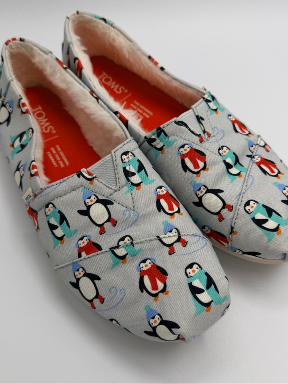 Toms Penguin-Print Slip-Ons in Light Gray with Teal and Red Accents